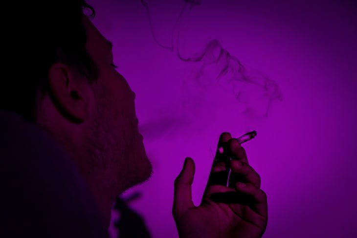 person smoking and misusing drugs