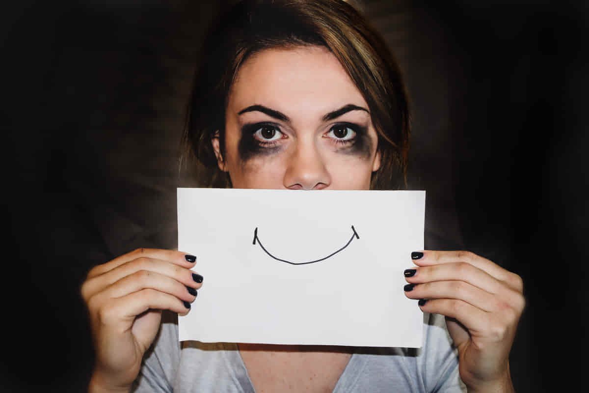 Girl trying to express fake smile