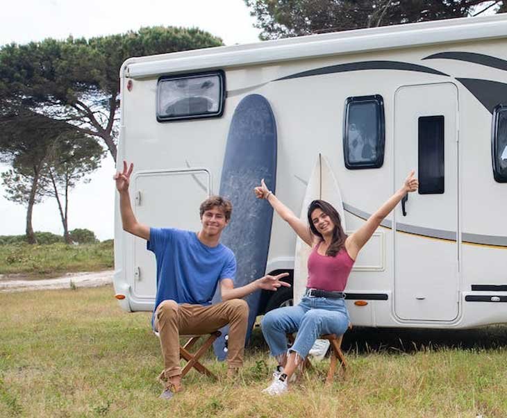 couple outside an RV
